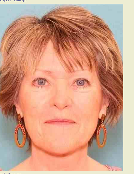 A photo of Cathy Gray, a 62-year-old woman, who has gone missing. Cathy is seen smiling wiht her mouth closed, with short brown hair and blue eyes.