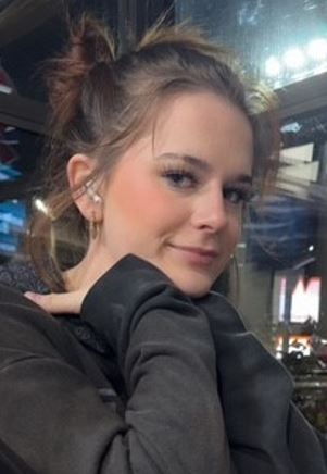 A photo of Adisen Daniels, a 16-year-old female, with light brown hair in a messy bun.